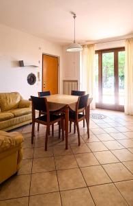 a living room with a dining room table and chairs at Le Cave Apartment in Sirolo
