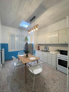 a kitchen with a table and chairs in a room at Aqua Mare Luxury Apartments in Amfilochía