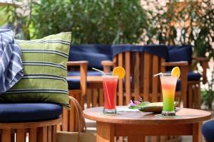 two drinks on a table on a patio at Neptune in Saly Portudal