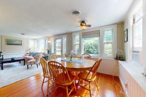 a dining room with a table and chairs at Garden Cottage By The Sea in Manchester
