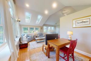 a dining room with a table and a living room at Garden Cottage By The Sea in Manchester +24 photos