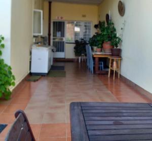 a living room with a table and a kitchen at Kwa-Dlamathe Guesthouse in Volksrust