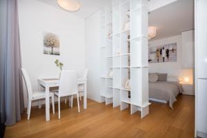 een slaapkamer met een bed en een tafel en stoelen bij Luxury 1BDRM on the 28th floor in Bratislava