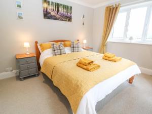 a bedroom with a bed with two towels on it at Farm View Lodge in Stroud