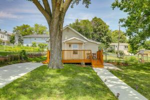 a house with a large tree in the yard at Cozy Omaha Vacation Rental 6 Miles to Downtown! in Omaha