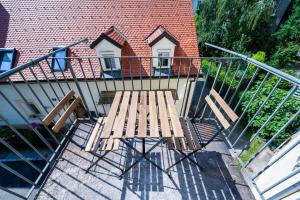 a wooden bench sitting on top of a balcony at Premium apartment - walking distance to city center in Graz