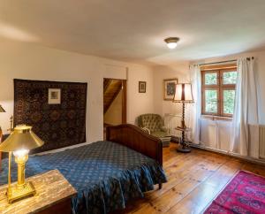a bedroom with a bed and a table with a lamp at Frankówka in Łagów