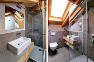 a bathroom with a sink and a shower and a toilet at Ferienhaus Alpenblick in Mittenwald +27 photos