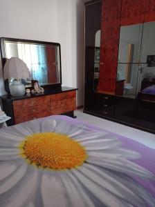 a flower laying on a bed in a bedroom at B&B Angel's in Canosa Sannita