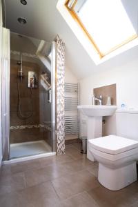 a bathroom with a shower and a toilet and a sink at Cherry Tree Apartment 