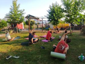 a group of people sitting in the grass doing yoga at Chillsteps Hostel in Fethiye