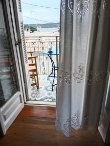 an open door to a balcony with a table at George Traditional House in Pylos