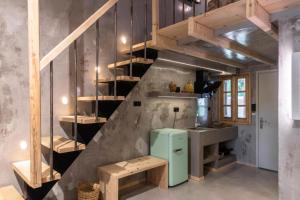 a kitchen with a staircase and a green refrigerator at Limna Afitos in Afitos