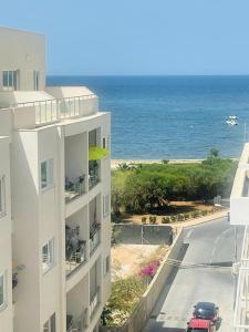 a view of the ocean from a building at Side-seaview apartment near beach and close to St. Julians in Baħar iċ-Ċagħaq