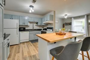 a kitchen with white appliances and a wooden table at Dog-Friendly Baraboo Vacation Rental with Yard! in Baraboo
