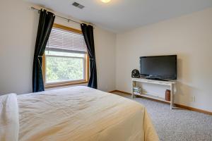 a bedroom with a bed and a flat screen tv at Dog-Friendly Baraboo Vacation Rental with Yard! in Baraboo