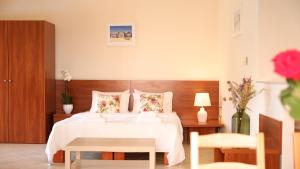 Postel nebo postele na pokoji v ubytování Corinthian Village