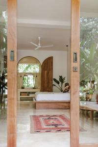 a bedroom with a bed and a mirror at The Nook RESORT in Devinuwara