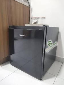 a black appliance sitting on the floor in a room at MySantai Homestay Padang Serai in Padang Serai