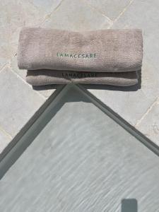 a pair of towels sitting on top of a table at Lamacesare in Cisternino