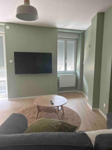 a living room with a couch and a table at 101 in Jasseron +3 photos