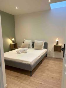 a bedroom with a bed with white sheets and pillows at 101 in Jasseron
