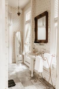 a white bathroom with a sink and a mirror at Ellerbeck Bed & Breakfast in Salt Lake City