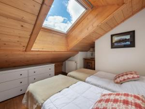 a attic bedroom with two beds and a skylight at Duplex à Méribel Village : Ski aux pieds, Piscine et Spa inclus - FR-1-566-6 in Les Allues +10 photos
