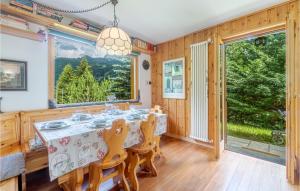 a dining room with a table and chairs and a large window at Le Coeur De Lea in Champoluc