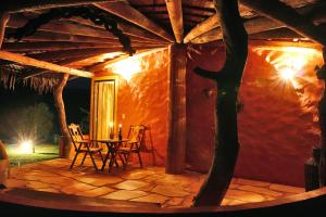 a patio with a table and chairs in a house at Salto Corumbá Hotel Camping Clube in Corumbá de Goiás