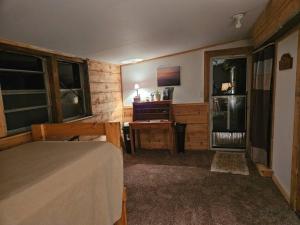 a bedroom with a bed and a desk and window at Twin Pines Lake House in Gwinn