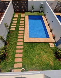 un patio trasero con piscina y césped en Chalet villa QUE POUR LES FAMILLES, en Imouzzer Kandar