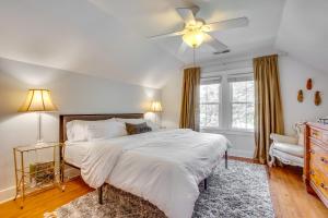 a bedroom with a bed and a ceiling fan at Charming Louisville Retreat with Patio and Fireplace! in Louisville