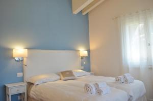 En eller flere senger på et rom på Villa Santa Margherita di Pula