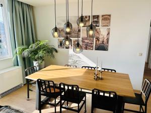 a dining room with a wooden table and chairs at Urbanstay Suites - Grand Place 2 Bd Apartment in Brussels +12 photos
