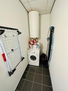 a small laundry room with a washer and dryer at Urbanstay Suites - Grand Place 2 Bd Apartment in Brussels