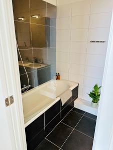 a bathroom with a tub and a sink at Urbanstay Suites - Grand Place 2 Bd Apartment in Brussels