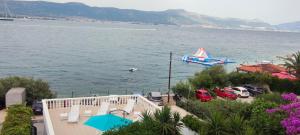 a large body of water with a boat in the water at Villa Fjaba - by the sea - with the big terraces & great sea view in Trogir