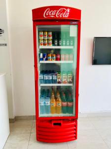 an old cocacola soda refrigerator with its door open at Hostel Meio do Mundo in Macapá