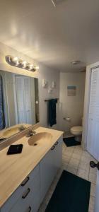a bathroom with a sink and a toilet at Coastline Penthouse Condo in Daytona Beach Shores