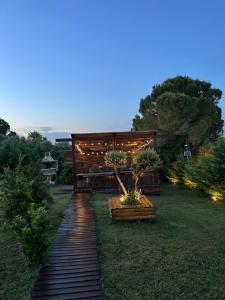 a garden with a building with lights on it at Luxury Wooden Villas in Makrygialos
