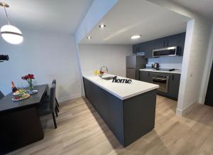 a kitchen with a sink and a counter top at Les Suites Hotel in Ottawa