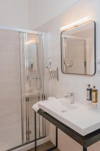 a bathroom with a sink and a shower at Dear Faro - Guest House in Faro