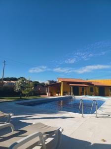 una piscina con 2 tumbonas junto a un edificio en Quintinha dos Amores, en Vila Verde