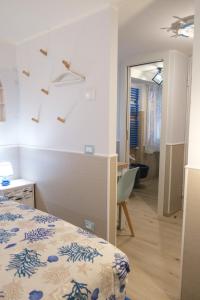 a bedroom with a bed and a desk and a mirror at Appartamenti Vale Mare 2 in Chioggia