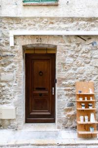 uma porta de um edifício de pedra com uma porta de madeira em Appartements climatisés - Vieil Antibes em Antibes