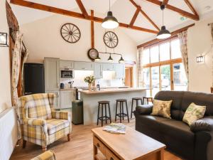 a living room with a couch and a table at Quoit X Barn in Tiverton