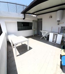 a patio with a table and a tv on a building at Socrate Suite in Messina