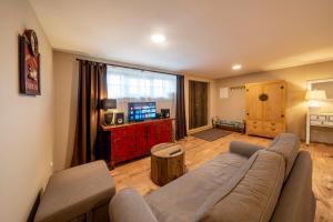 a living room with a couch and a table at Prague West - Studio Chyne with Terrace in Chýně
