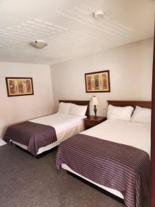 a hotel room with two beds in a room at Grantview Inn in Surrey